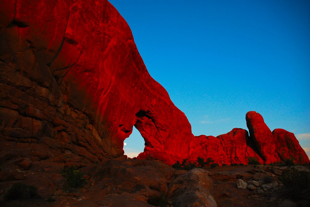 Moon view through North Window Arch in Arches National Park